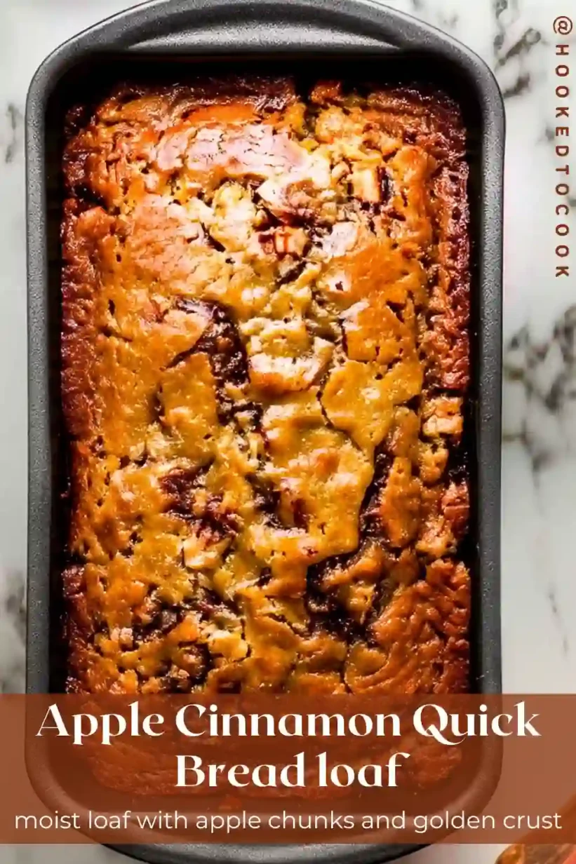 Apple Cinnamon Quick Bread golden loaf cooling in a pan on marble surface