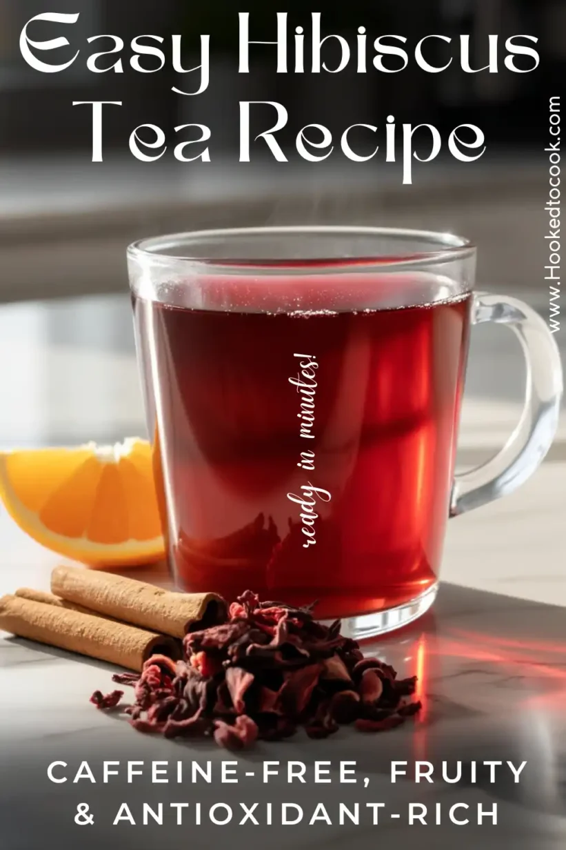 how to make hibiscus tea : a glass cup on marble countertop with cinnamon and orange slice