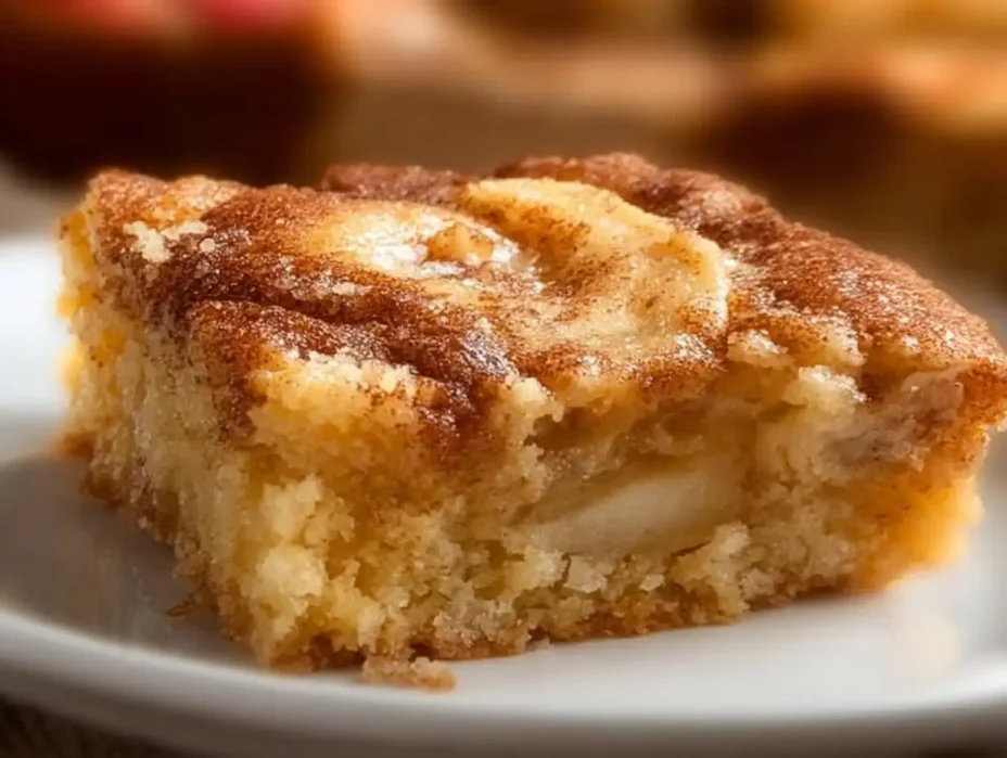 Delicious apple cinnamon sheet cake topped with fresh apple slices and cinnamon