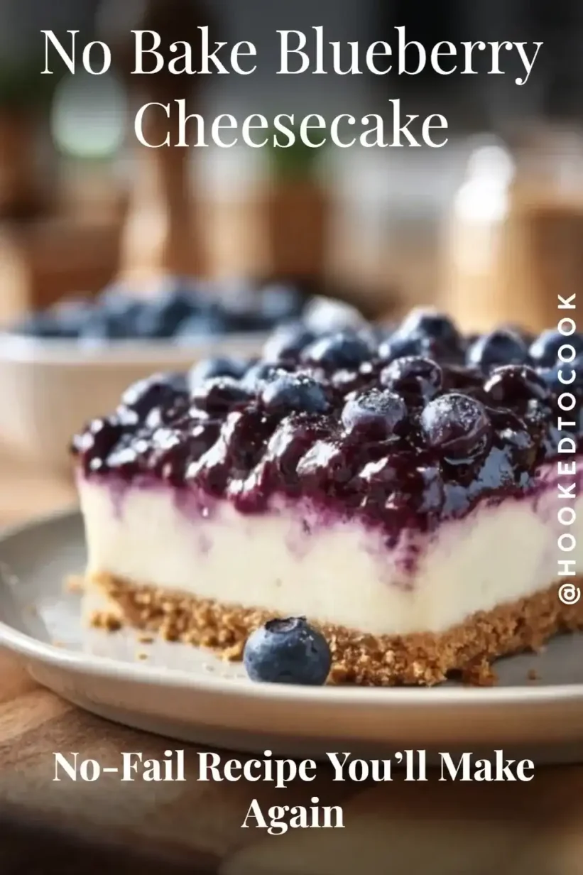 Blueberry cheesecake slice with graham crust, creamy center, and glossy blueberry topping on white plate