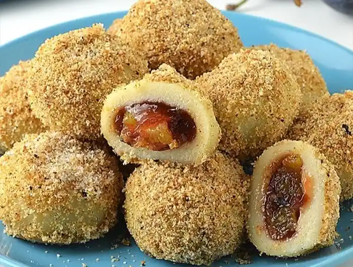 Delicious homemade plum dumplings ready to enjoy as a comforting dessert.