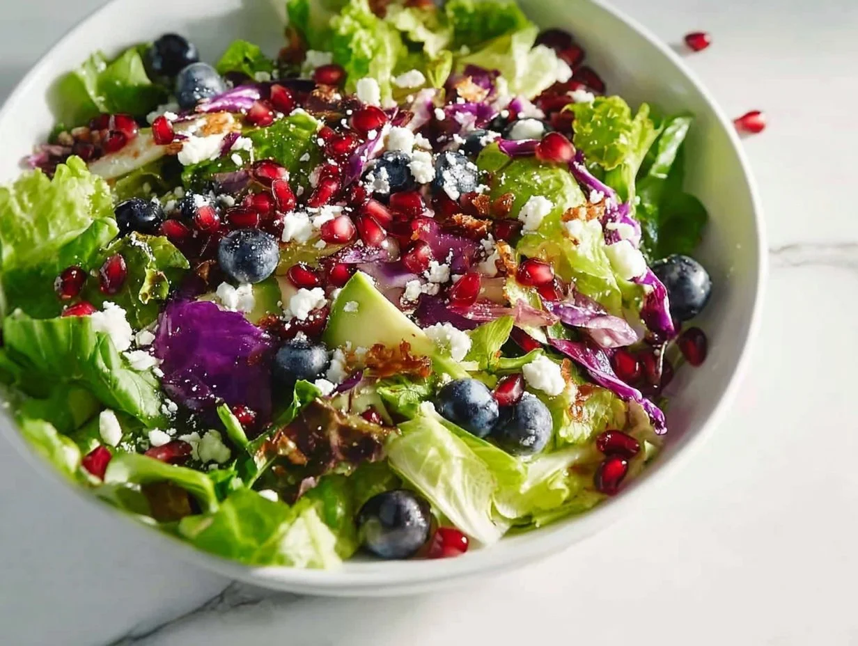 Vibrant blueberry and pomegranate salad with fresh greens