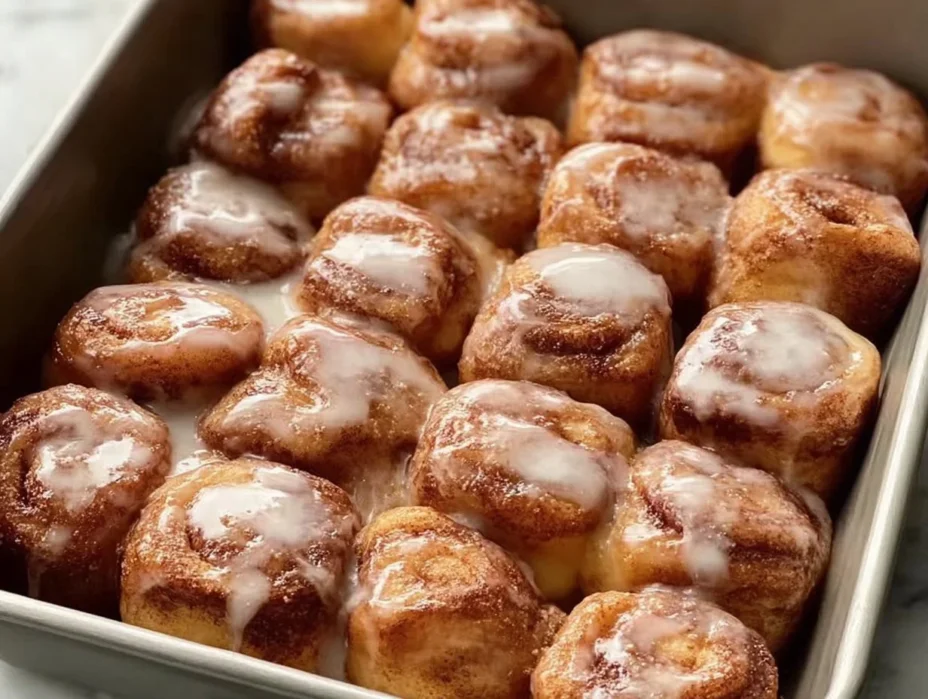 Delicious cinnamon roll bites topped with icing and cinnamon sugar.
