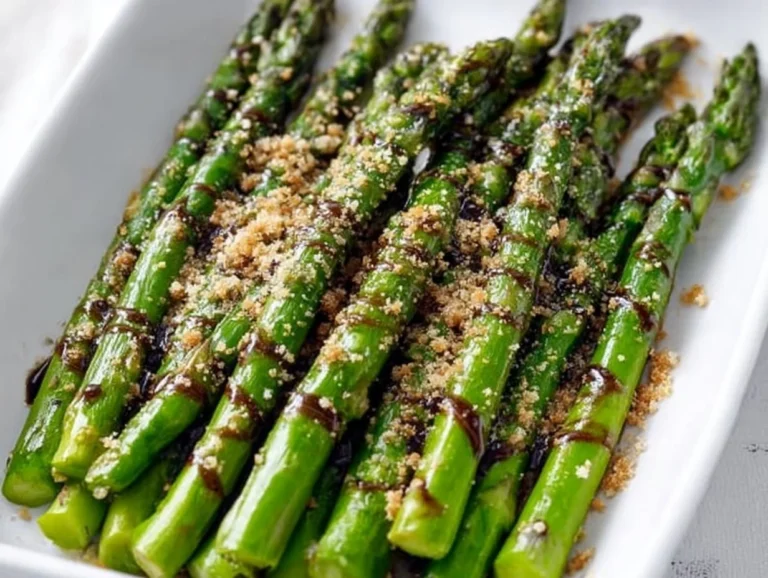 Flavorful asparagus drizzled with balsamic glaze on a white plate