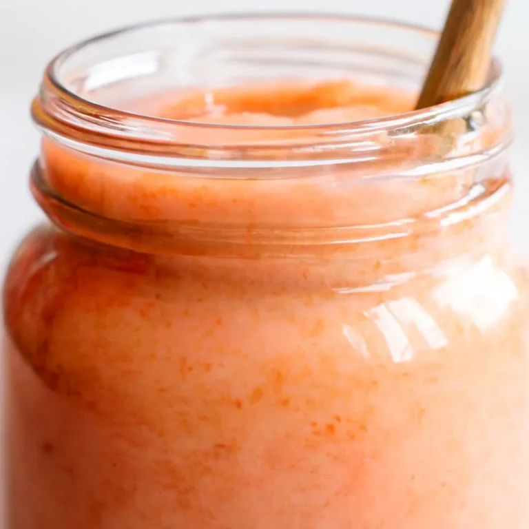 Creamy rhubarb curd in a jar, perfect for spreading on toast and desserts.