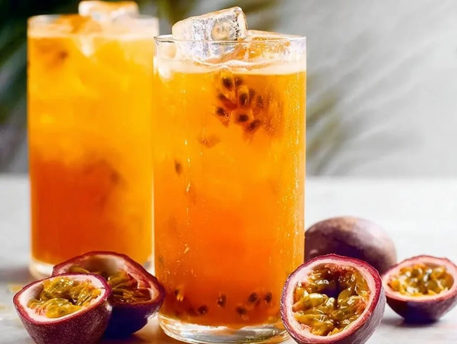 Refreshing Passionfruit Tea in a clear glass with tropical fruits