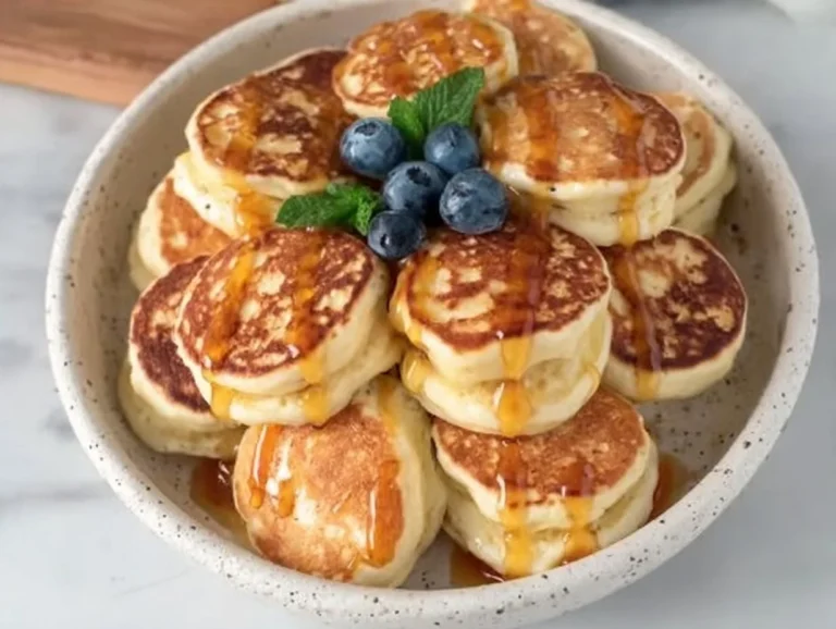 Fluffy lemon pancakes stacked with a slice of lemon on top