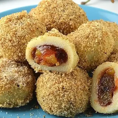 Delicious homemade plum dumplings ready to enjoy as a comforting dessert.