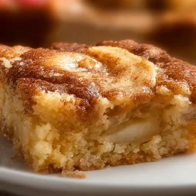 Delicious apple cinnamon sheet cake topped with fresh apple slices and cinnamon
