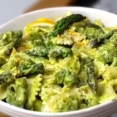 Delicious plate of asparagus pasta garnished with fresh herbs