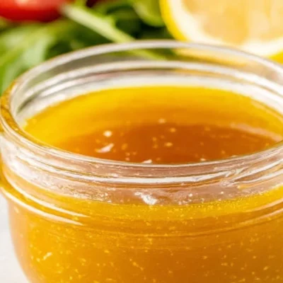 A bowl of homemade vinaigrette dressing with fresh ingredients.