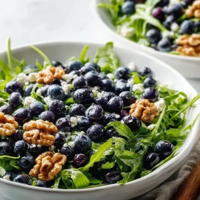 Blueberry Walnut Salad drizzled with Honey Lemon Vinaigrette on a plate