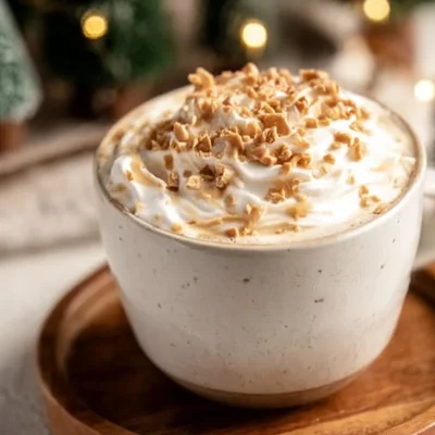 Caramel Burnt Cream Latte with whipped cream and caramel drizzle