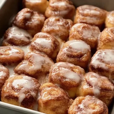 Delicious cinnamon roll bites topped with icing and cinnamon sugar.