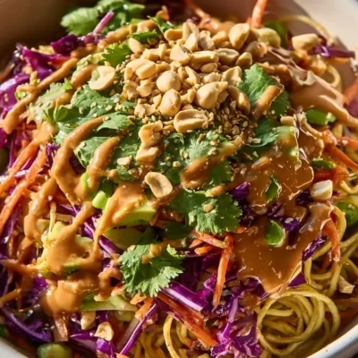 Colorful cold pasta salad with fresh vegetables and dressing