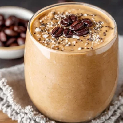 Delicious creamy coffee smoothie topped with chocolate shavings and whipped cream.