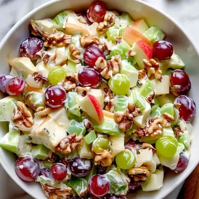 Waldorf Salad with red and green grapes, apples, and walnuts coated in creamy dressing