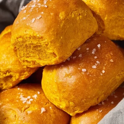 A plate of delicious sweet potato rolls, baked to perfection, served warm.