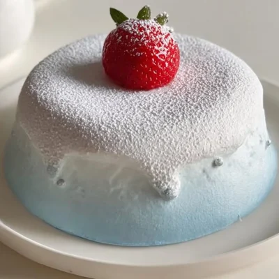 A slice of First Snow Lava Angel Cake, showcasing its fluffy texture and delicious layers.