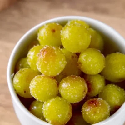 A bowl of frozen grapes, a refreshing and healthy snack option.