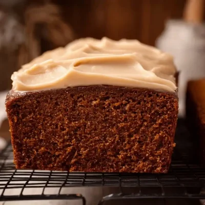Delicious gingerbread loaf served on a rustic wooden table, perfect winter treat.