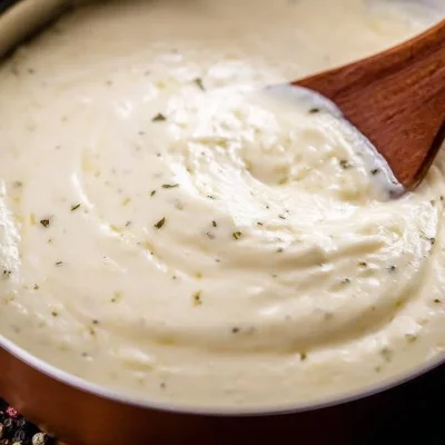 Delicious homemade Alfredo Sauce in a bowl, ready to serve over pasta.