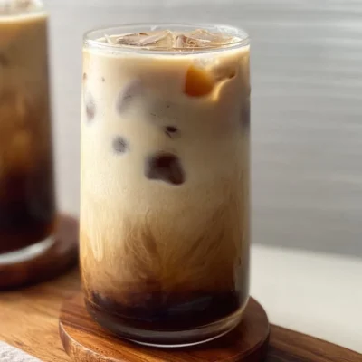 Iced Brown Sugar Latte in a glass with ice and caramel drizzle