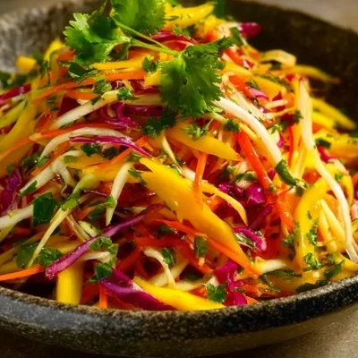 Colorful Mango Slaw served in a bowl, showcasing vibrant summer ingredients.