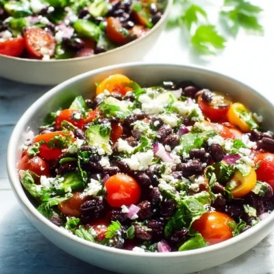 Mediterranean black bean salad topped with fresh herbs and feta cheese.