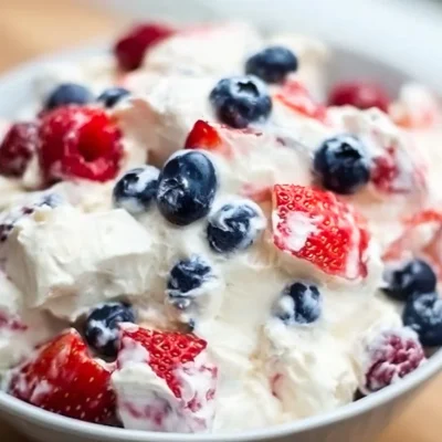Red White and Blue Cheesecake Salad with berries and creamy layers