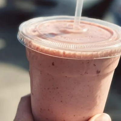 Refreshing strawberry protein smoothie in a glass with fresh strawberries