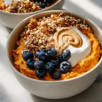 Delicious sweet potato breakfast bowls topped with nuts and fruits