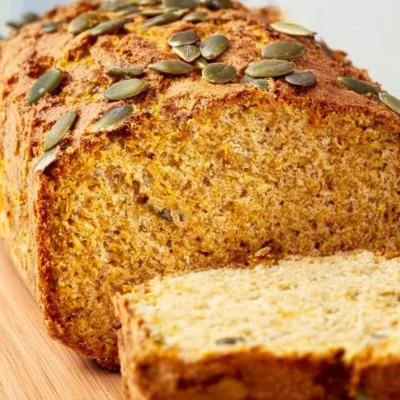 Slices of vegan chickpea bread on a wooden cutting board